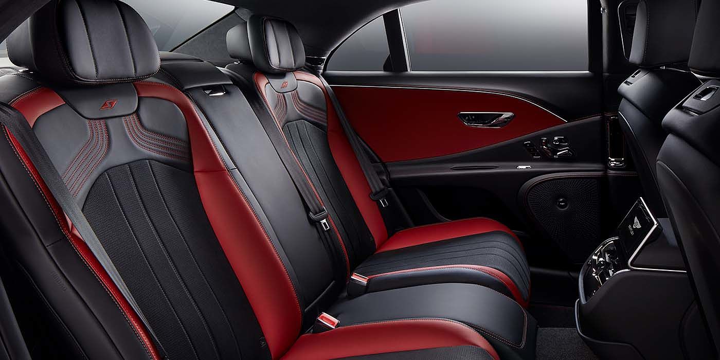 Bentley Basel Bentley Flying Spur S sedan rear interior in Beluga black and Hotspur red hide with S stitching