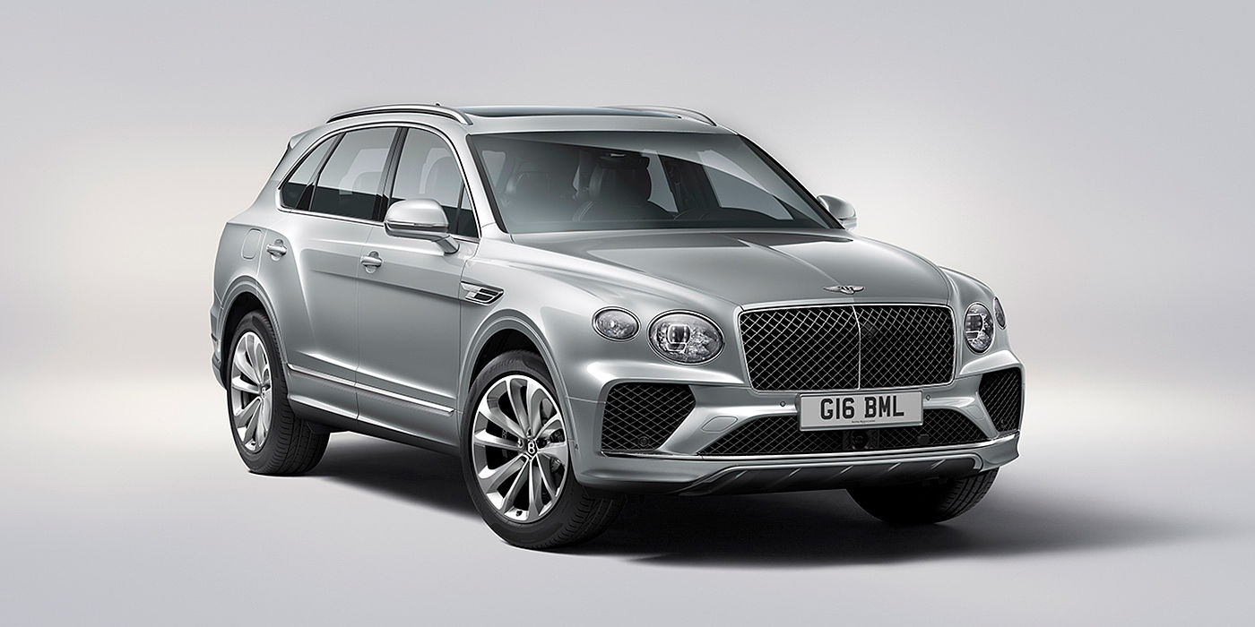 Bentley Basel Bentley Bentayga in Moonbeam paint, front three-quarter view, featuring a matrix grille and elliptical LED headlights.