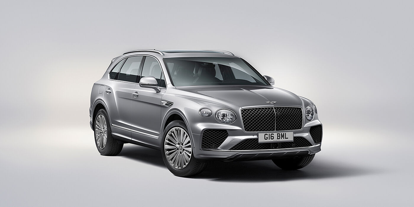 Bentley Basel Bentley Bentayga luxury SUV front three quarter view in Moonbeam paint with matrix grille and 21″ 5 spoke painted wheels