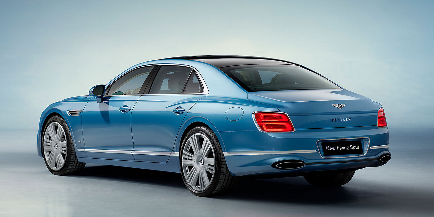 Bentley Basel New Bentley Flying Spur Azure sedan rear view in Light windsor blue by Mulliner paint with 22 inch Azure wheels and chrome exterior details