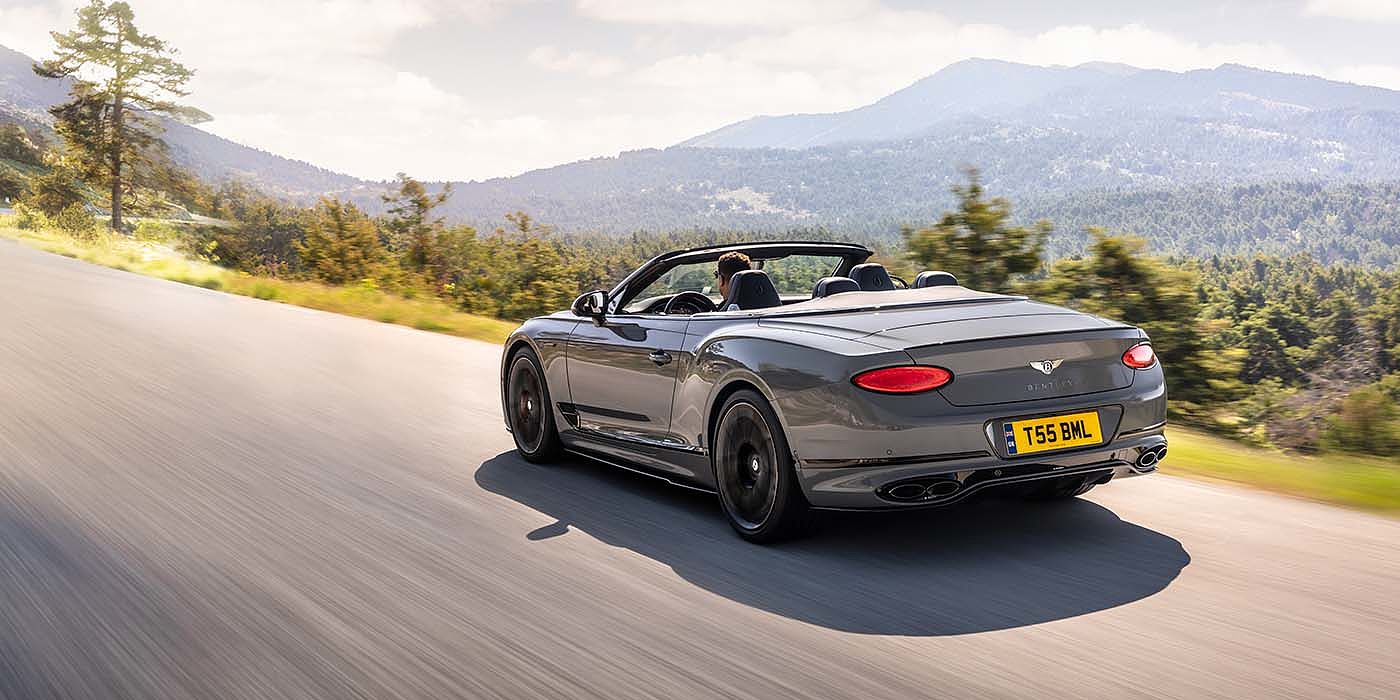 Bentley Basel Bentley Continental GTC S convertible in Cambrian Grey paint rear 34 dynamic driving