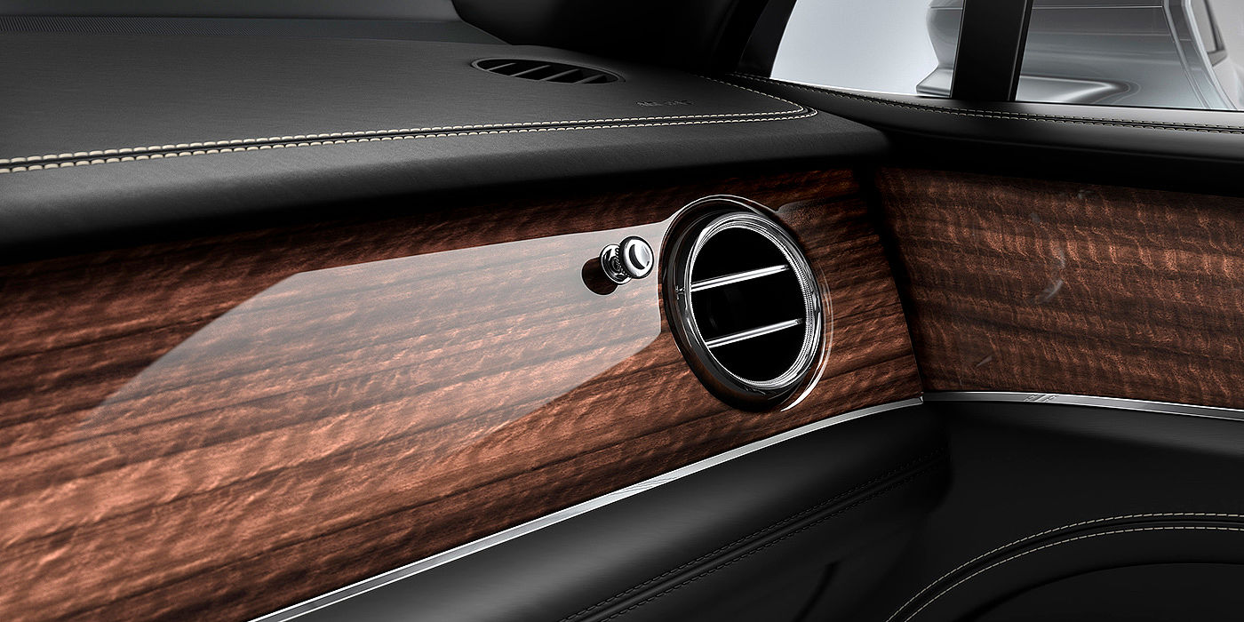 Bentley Basel Bentley Bentayga front interior Crown Cut Walnut veneer and chrome air vent.