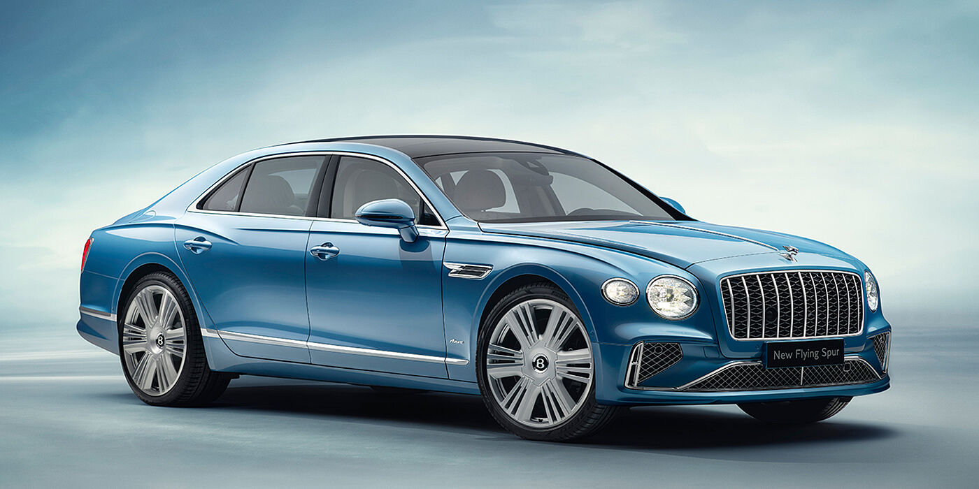 Bentley Basel New Bentley Flying Spur Azure sedan front view in Light windsor blue by Mulliner paint with 22 inch Azure wheels and chrome exterior details
