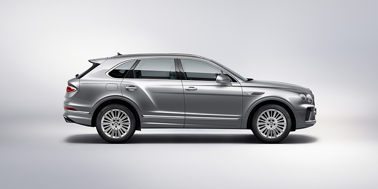 Bentley Basel Bentley Bentayga SUV side profile in Moonbeam silver paint against white background featuring 21 inch 5 spoke wheels