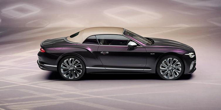 Bentley Basel Bentley Continental GTC Mulliner convertible in profile with hood up, in Tanzanite Purple paint and 22 inch Mulliner painted and polished wheels