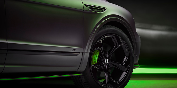 Bentley Basel Bentley Bentayga S Black Edition SUV exterior wheel detail with Cyber Green brakes with Anthracite Satin paint