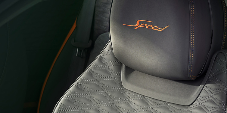 Bentley Basel Bentley Continental GT Speed coupe seat detail in Gravity Grey hide and Speed emblem in Mandarin by Mulliner coloured embroidery