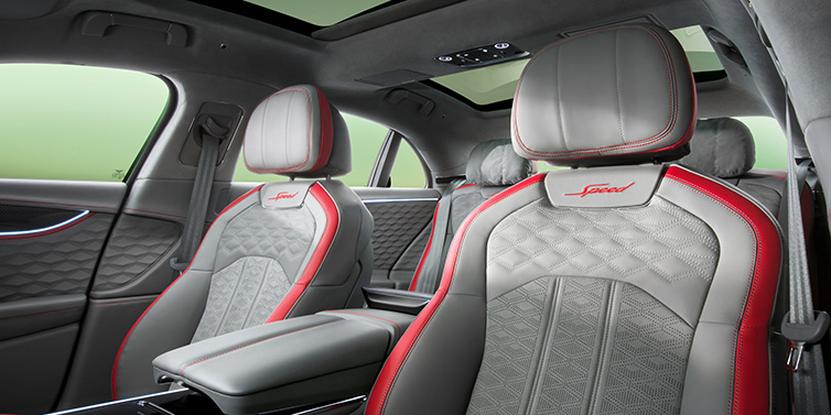 Bentley Basel Bentley Flying Spur Speed sedan interior showing front and rear seats in Hotspur red and Gravity Grey hides, with Speed seat emblems