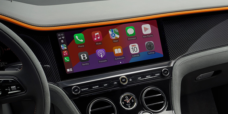 Bentley Basel Bentley Continental GT Speed coupe front interior centre console with MMI screen featuring Apps surrounded by Mandarin by Mulliner and Gravity Grey hides